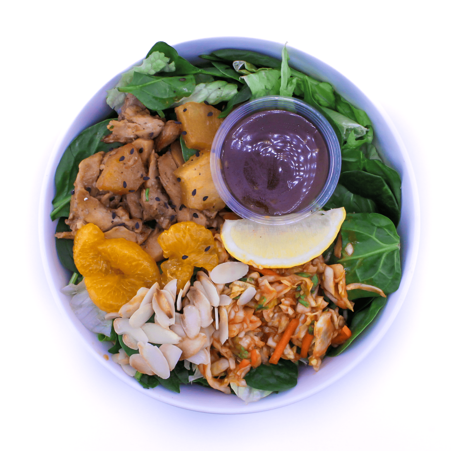 Citrus Kick - Teriyaki glazed chicken and pineapples, mixed greens, mandarin oranges, spicy slaw, almonds, black sesame seeds, sesame dressing - Contains Nuts