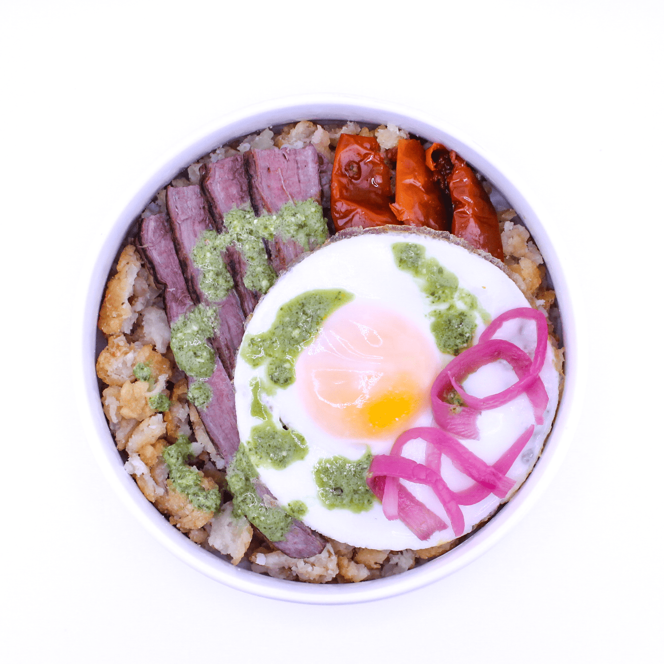 Lumberjack Bowl - Grilled flank steak, crispy potato hash, roasted tomatoes, pickled red onions, green goodness dressing, cage-free egg over easy