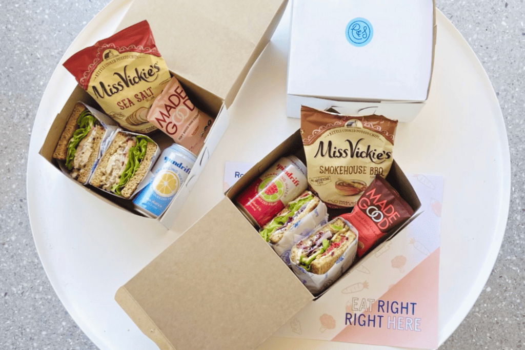 BOXED LUNCH - Individual boxed meals containing a sandwich or salad with a snack and drink.