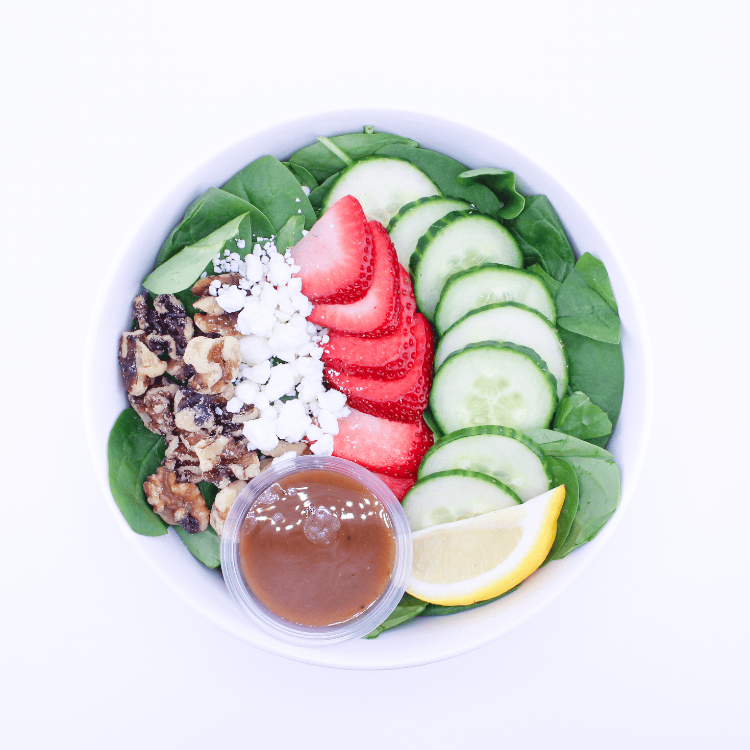 Strawberry slices, cucumbers, goat cheese, candied walnuts, spinach, balsamic vinaigrette